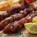 Grilled meat skewers on a table, closeup view Royalty Free Stock Photo