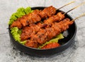 grilled meat on skewers or thit nuong xien que witth lettuce leaf served in dish isolated on grey background top view of singapore Royalty Free Stock Photo