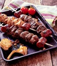 Grilled Meat Skewers and Vegetables on Hot Pan