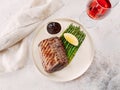 Grilled meat steak on plate with lemon and asparagus