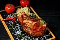 Grilled meat on a stone board. Appetizing Pork steak with herbs and spices. Close-up Royalty Free Stock Photo