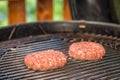Grilled meat - two burgers on an outdoor grill Royalty Free Stock Photo