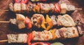 Grilled meat with vegetables. Barbecued shish kebab or shashlik on sticks Royalty Free Stock Photo