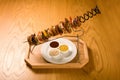 Grilled meat and vegetables on a skewer and sauces on a plate