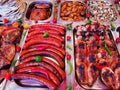 Grilled meats - sausages, pork and grilled chicken in stainless steel trays