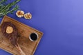 Grilled Medium rare barbecue Steak on bone with spices served on a rustic wooden board with sauce over blue background. Royalty Free Stock Photo