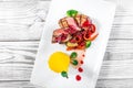 Grilled medium rare beef with pear, grilled vegetables, broccoli, berries sauce on plate on wooden background Royalty Free Stock Photo