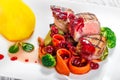 Grilled medium rare beef with pear, grilled vegetables, broccoli, berries sauce on plate on wooden background close up Royalty Free Stock Photo