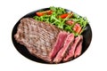 Grilled medium rare flank beef steak with salad in a plate. Isolated on white background. Top view. Royalty Free Stock Photo