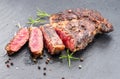 Grilled medium rare ribeye steak on gray stone plate Royalty Free Stock Photo