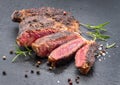 Grilled medium rare ribeye steak on gray stone plate Royalty Free Stock Photo