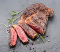 Grilled medium rare ribeye steak on gray stone plate Royalty Free Stock Photo