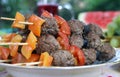 Grilled meetballs with vegetables on wooden sticks