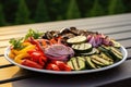 grilled mixed veggies on a disposable plate for bbq