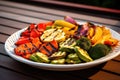 grilled mixed veggies on a disposable plate for bbq