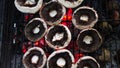 Grilled mushrooms on the hot flaming charcoal grill