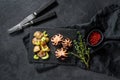 Grilled octopus. A side dish of roasted potatoes and celery. Black background. Top view. Space for text Royalty Free Stock Photo