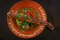 Grilled octopus tentacle Portuguese style with spinach, red peppers and potatoes at an al fresco restaurant in Porto Royalty Free Stock Photo