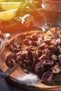 Grilled octopus tentacles on fork on rustic plate close view Royalty Free Stock Photo