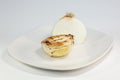 Grilled onion freshly removed from the grilled and placed on a white plate on the table