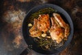 Grilled organic  pork cutlets with herbs on bone  in grill frying pan hot with smoke and hot oil just from fire, top view cooking Royalty Free Stock Photo