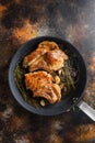 Grilled organic  pork cutlets with herbs on bone  in grill frying pan hot with smoke and hot oil just from fire, top view cooking Royalty Free Stock Photo