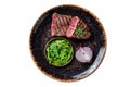 Grilled Oyster Top Blade beef meat steak on a plate with salad. Isolated on white background.