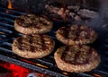 Grilled patties for burgers on charcoal