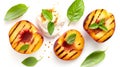 Grilled peach halves with fresh basil leaves and a dollop of cream on a white background