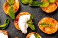 Grilled peaches, apricots, nectarines and ice cream dessert with mint on a black slate board. Food recipe background. Close up