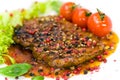 A grilled peppercorn - steak with tomato lettuce Royalty Free Stock Photo