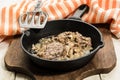 Grilled pig brain with onion in a cast iron pan Royalty Free Stock Photo