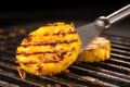 grilled pineapple with a metal spatula