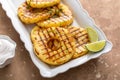 Grilled pineapple slices served with lime and whipped cream Royalty Free Stock Photo