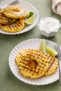 Grilled pineapple slices served with lime and whipped cream Royalty Free Stock Photo