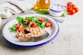 Grilled Pink salmon steak and salad on concrete background. Healthy food concept. Royalty Free Stock Photo