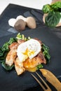 Grilled Pleurotus eryngii mushrooms with poached egg and spinach. Hot fried mushrooms on a spinach substrate is a