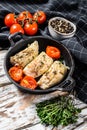 Grilled pollock or coalfish fillets in a pan. White background. Top view