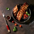 Grilled pork bbq ribs served with cherry tomatoes Royalty Free Stock Photo