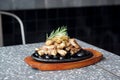 Grilled pork belly served on hot stones, Topped with chopped spring onions and rosemary leaf, Korean BBQ style. Royalty Free Stock Photo