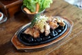 Grilled pork belly served on hot stones, Topped with chopped spring onions and rosemary leaf, Korean BBQ style Royalty Free Stock Photo