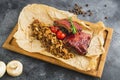 Grilled pork, buckwheat with mushroom and tomato on wooden cutting board Royalty Free Stock Photo