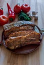 Grilled pork chop with bay leaf, pepper, garlic and dill on wooden board Royalty Free Stock Photo