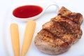 Grilled pork chop with Cranberry sauce and Mini Corn cob preserved on plate on wooden board Royalty Free Stock Photo