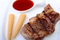 Grilled pork chop with Cranberry sauce and Mini Corn cob preserved on plate on wooden board Royalty Free Stock Photo