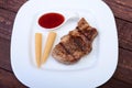 Grilled pork chop with Cranberry sauce and Mini Corn cob preserved on plate on wooden board Royalty Free Stock Photo