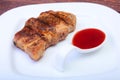 Grilled pork chop with Cranberry sauce on plate on wooden board Royalty Free Stock Photo