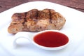 Grilled pork chop with Cranberry sauce on plate on wooden board Royalty Free Stock Photo