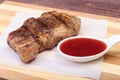 Grilled pork chop with Cranberry sauce on plate on wooden board Royalty Free Stock Photo