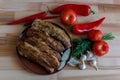 Grilled pork chop with pepper, garlic and dill on wooden board Royalty Free Stock Photo